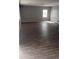 A spacious living room with modern flooring and large windows at 374 S Verdad Ln, Casa Grande, AZ 85194