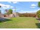 Large backyard with grass, a shed, and a tall bush at 416 W Chambers St, Phoenix, AZ 85041