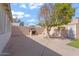 Spacious backyard patio with an outdoor fireplace and mature trees, ideal for entertaining guests at 416 W Chambers St, Phoenix, AZ 85041