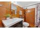 Bathroom featuring a white vanity sink and a shower with brown tile at 416 W Chambers St, Phoenix, AZ 85041