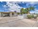 Charming single-story home with a white fence, lush landscaping, and a covered carport at 416 W Chambers St, Phoenix, AZ 85041