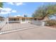 Inviting single-story home with a secure white fence and a convenient covered carport at 416 W Chambers St, Phoenix, AZ 85041