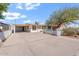 Welcoming single-story home featuring a white fence, mature landscaping, and a covered carport at 416 W Chambers St, Phoenix, AZ 85041