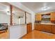 Well-lit kitchen featuring wooden cabinets, a breakfast bar, and modern appliances at 416 W Chambers St, Phoenix, AZ 85041