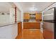 Functional kitchen with wooden cabinets, tiled floors, and essential appliances for cooking and storage at 416 W Chambers St, Phoenix, AZ 85041
