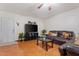 Living room with dark furniture, orange tile flooring and a white door at 416 W Chambers St, Phoenix, AZ 85041