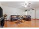 Comfortable living room with two leather sofas, tile flooring and a ceiling fan at 416 W Chambers St, Phoenix, AZ 85041