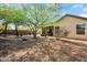 A well-maintained backyard with outdoor seating and mature landscaping at 42823 N Courage Trl, Anthem, AZ 85086