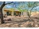 Backyard featuring an outdoor sitting area and lush landscaping with mature trees at 42823 N Courage Trl, Anthem, AZ 85086