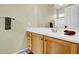 Bathroom vanity with wooden cabinets, white countertops and large mirror at 42823 N Courage Trl, Anthem, AZ 85086
