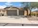 Charming home with a neutral color palette, three-car garage and desert landscaping in a sunny setting at 42823 N Courage Trl, Anthem, AZ 85086