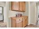 Hallway with built-in oak cabinets and counter space at 42823 N Courage Trl, Anthem, AZ 85086