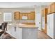 Well-equipped kitchen with a central island, light wood cabinetry, and stainless-steel appliances at 42823 N Courage Trl, Anthem, AZ 85086