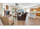 Open-concept living area with fireplace, dining area, and seamless flow into the kitchen at 42823 N Courage Trl, Anthem, AZ 85086