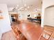 Dining room with wood table and chairs open to a kitchen and living area creating an inviting flow at 440 E March St, San Tan Valley, AZ 85140