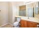 Bathroom featuring a vanity with a sink, toilet, and a large mirror above at 45049 W Cypress Ln, Maricopa, AZ 85139