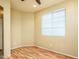 Cozy bedroom featuring wood floors, a window for natural light, and a comfortable layout at 45049 W Cypress Ln, Maricopa, AZ 85139