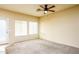 Cozy bedroom with plush carpeting, a ceiling fan, and lots of natural light from big windows at 45049 W Cypress Ln, Maricopa, AZ 85139