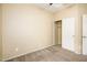Neutral bedroom featuring carpet, a closet with sliding doors, and ample natural light at 45049 W Cypress Ln, Maricopa, AZ 85139