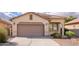 Charming single-story home with a two-car garage, neutral stucco exterior, and well-maintained landscaping at 45049 W Cypress Ln, Maricopa, AZ 85139