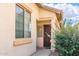 Inviting facade with a front door and trimmed window showcases curb appeal and natural light at 45049 W Cypress Ln, Maricopa, AZ 85139