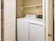 Enclosed laundry room featuring a full-size washer and dryer for added convenience at 45049 W Cypress Ln, Maricopa, AZ 85139