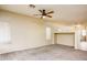 Spacious living room featuring neutral walls, carpet, and a ceiling fan for a comfortable living space at 45049 W Cypress Ln, Maricopa, AZ 85139