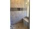 Modern tiled shower featuring a built-in seat and mosaic tile accents at 4593 W Agave Ave, Eloy, AZ 85131