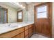 Bathroom features dual sinks, mirror, and a door to the exterior at 4621 E Onyx Ave, Phoenix, AZ 85028