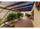 Shaded patio with exposed wood beams and brick flooring at 4621 E Onyx Ave, Phoenix, AZ 85028