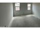 Unfinished bedroom with neutral walls featuring dual windows offering views of the surrounding construction at 47733 W Kenner Dr, Maricopa, AZ 85139