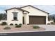 Charming single-Gathering home displaying stucco siding, neutral color palette, complemented by a well-manicured landscape at 47733 W Kenner Dr, Maricopa, AZ 85139