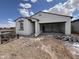 New home under construction featuring a two-car garage, textured stucco, and tile roof details at 47733 W Kenner Dr, Maricopa, AZ 85139