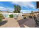Tranquil backyard with vibrant desert mural, lush desert plants, and patio, offering a peaceful outdoor retreat at 48 E Nolana Pl, San Tan Valley, AZ 85143
