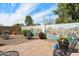 Charming backyard with a desert-themed mural, brick pavers, plants, and a cozy seating area, creating a peaceful retreat at 48 E Nolana Pl, San Tan Valley, AZ 85143