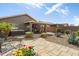 Expansive backyard featuring a hot tub, covered patio, desert landscaping, and ample space for outdoor entertaining at 48 E Nolana Pl, San Tan Valley, AZ 85143