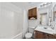 Bathroom featuring a shower-tub combo with white shower curtain and wood vanity with mirror and medicine cabinet at 48 E Nolana Pl, San Tan Valley, AZ 85143