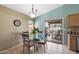 Casual dining space with a glass table set, adjacent to the kitchen and featuring natural light at 48 E Nolana Pl, San Tan Valley, AZ 85143