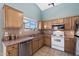 Functional kitchen with oak cabinets, tile backsplash, stainless steel appliances, and a bright window at 48 E Nolana Pl, San Tan Valley, AZ 85143