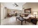 Cozy living room with tile flooring, ceiling fan, and comfortable seating arrangements for relaxation at 48 E Nolana Pl, San Tan Valley, AZ 85143