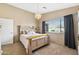 Cozy bedroom with a decorative chandelier, comfortable bed, and natural light, creating a relaxing retreat at 48 E Nolana Pl, San Tan Valley, AZ 85143