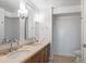 Bathroom featuring double sinks with modern fixtures, a wooden vanity, and plenty of storage space at 4808 N 24Th St # 908, Phoenix, AZ 85016