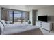 Bedroom featuring large windows with city views and a modern dresser with a large television at 4808 N 24Th St # 908, Phoenix, AZ 85016