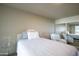 Bedroom featuring a bed, glass side table, and relaxing chair next to a mirrored closet at 4808 N 24Th St # 908, Phoenix, AZ 85016