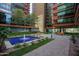 Outdoor courtyard highlighting a fountain, garden beds, walking path, and building architecture at 4808 N 24Th St # 908, Phoenix, AZ 85016