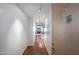 Bright condo hallway with hardwood floors illuminated by modern track lighting leads to the living space at 4808 N 24Th St # 908, Phoenix, AZ 85016