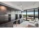 Built-in desk and cabinets in home office; plush couch and large window included at 4808 N 24Th St # 908, Phoenix, AZ 85016