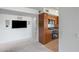 Open-concept living space leads to kitchen with wood cabinetry, tiled floors, and stainless appliances at 4808 N 24Th St # 908, Phoenix, AZ 85016