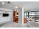 Spacious living area with modern bar, and open kitchen concept, featuring large windows at 4808 N 24Th St # 908, Phoenix, AZ 85016