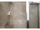 Shower featuring stylish tile walls and a shower head with a mounted faucet at 4808 N 24Th St # 908, Phoenix, AZ 85016